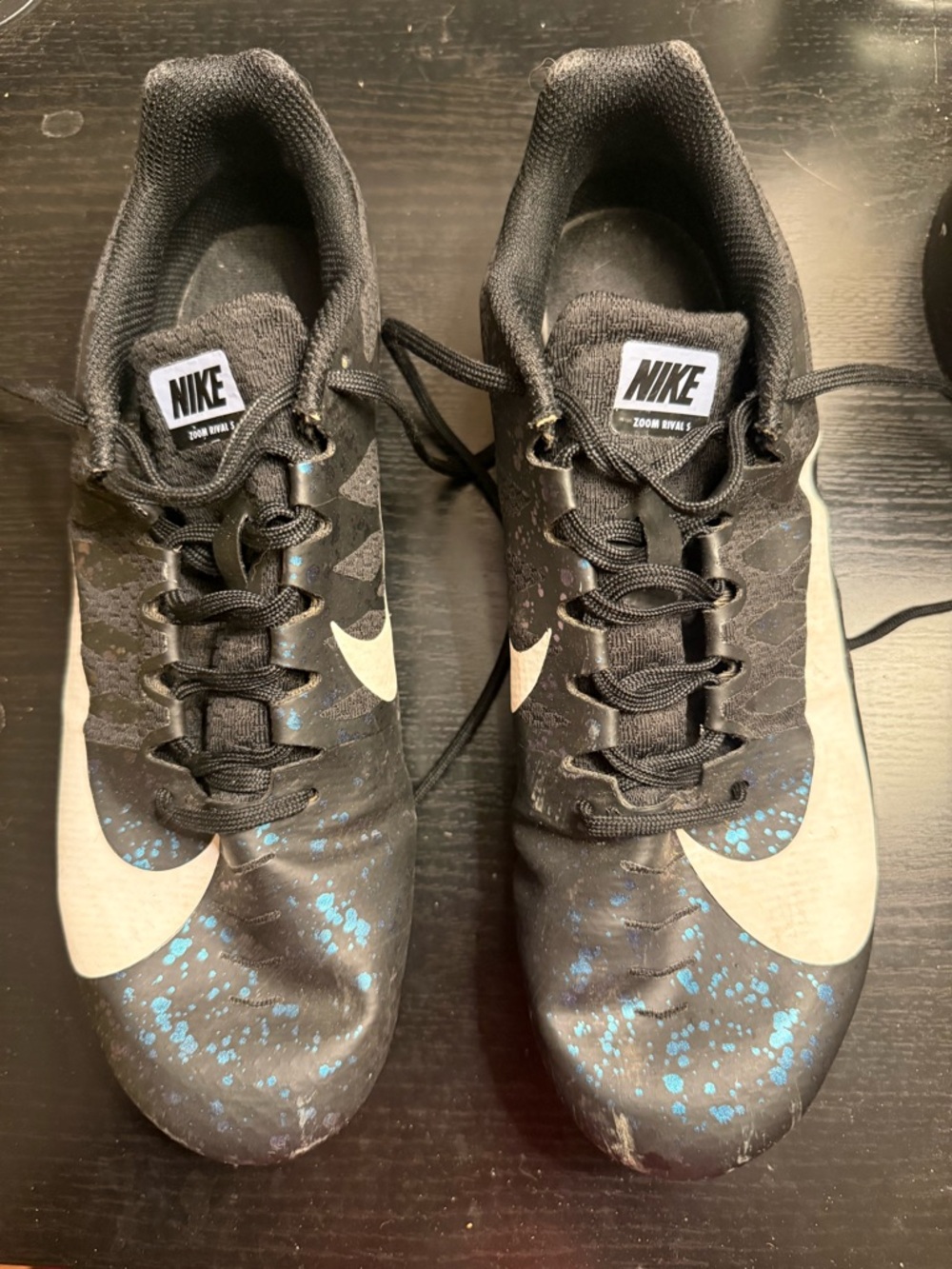 Nike Zoom rival s track spikes with White Swoosh and Blue Splash.